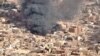 An aerial view of the black smoke and flames from a market in Omdurman, Sudan, May 17, 2023.