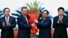 Vietnamese Prime Minister Pham Minh Chinh, right, congratulates Vietnamese President To Lam with flowers as he was confirmed the new Community Party Chief, the country's most powerful role, on Aug. 3, 2024, Hanoi, Vietnam. 