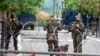 NATO Kosovo Force (KFOR) soldiers stand guard behind razor wire fence in the town of Zvecan, Kosovo, June 5, 2023.