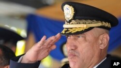 FILE - Honduras Police Chief Gen. Juan Carlos Bonilla Valladares, also known as the Tiger, or 'El Tigre,' salutes during an event in Tegucigalpa, Honduras, Dec. 21, 2012. 