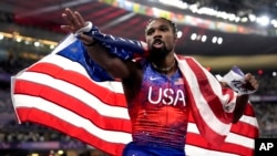 Noah Lyles, of the United States, celebrates after winning the men's 100-meters final at the 2024 Summer Olympics, in Saint-Denis, France, Aug. 4, 2024.