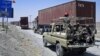 Paramilitary soldiers escort a convoy of trucks carrying supplies for NATO troops in Afghanistan, before crossing into Afghanistan from Pakistan, July 16, 2012.