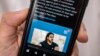A person in the Cypriot capital Nicosia checks a mobile phone on December 12, 2022, displaying a Tweet about the execution announced by Iranian authorities of Majidreza Rahnavard, the second capital punishment linked to nearly three months of protests.