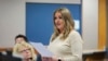 FILE - Jenna Ellis reads a statement inside Fulton Superior Court Judge Scott McAfee's Fulton County, Ga., courtroom, Oct. 24, 2023, in Atlanta. 