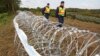 Hungarian police officers patrol an area at the temporary border fence positioned at the green border between Hungary and Croatia at Zakany, 234 km (145 miles) southwest of Budapest, Hungary, Sept. 30, 2015.