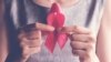 woman holding pink ribbon, breast cancer awareness, October pink concept
