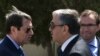FILE - Cypriot President Nicos Anastasiades, left, and breakaway Turkish Cypriot leader Mustafa Akinci, right, talk at the disused Nicosia airport inside a United Nations controlled buffer zone in this divided island of Cyprus, Sept. 14, 2016. 