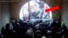 This image from video from the U.S. Justice Department contained in the sentencing memorandum, and annotated by the source, shows David Nicholas Dempsey stomping on police officers in the Lower West Terrace Tunnel at the U.S. Capitol on Jan. 6, 2021, in Washington.