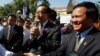 Opposition leader of Cambodia National Rescue Party Sam Rainsy, center, delivers a speech next to his Deputy President Kem Sokha, right, during a gathering to mark Human Rights Day, in front of National Assembly, in Phnom Penh, Cambodia, Wednesday, Dec. 10, 2014. 