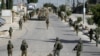 Tentara Israel terlihat di Balata, sebuah kamp pengungsi Palestina di Nablus, Tepi Barat, Kamis, 23 November 2023. (AP Photo/Majdi Mohammed)