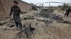 Pakistani paramilitary soldiers check the site of an attack by militants in the small town of Matni, near Peshawar, Pakistan, Oct. 15, 2012. 