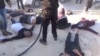 FILE - A still image taken from a video posted to a social media website on April 4, 2017, shows people lying on the ground, said to be in the town of Khan Sheikhoun, after what rescue workers described as a suspected gas attack in rebel-held Idlib, Syria.
