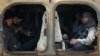 Rebel fighters ride a military vehicle with their weapons in Dahiyet al-Assad, west Aleppo city, Syria, Oct. 30, 2016. 