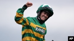 Rachael Blackmore ridding Minella Times celebrates after winning the Randox Grand National Handicap Chase on the third day of the Grand National Horse Racing meeting at Aintree racecourse, near Liverpool, England, April 10, 2021.