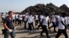 Migrants are escorted by Italian police after disembarking from Vos Hestia ship of NGO "Save the Children" at the Sicilian harbor of Augusta, Italy, Aug. 4, 2017.