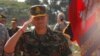 Lt. Gen. Hun Manet, son of Cambodian Prime Minister Hun Sen and deputy commander of the Royal Cambodian Army and commander of the National Counter Terror Special Force, walks through honorary guards as his arrives for presiding over a U.S.-backed peacekeeping exercise dubbed "Angkor Sentinel 2014" at the Cambodian tank command headquarters in Kampong Speu province, 60 kilometers (37 miles) west of Phnom Penh, Cambodia, Monday, April 21, 2014. (AP Photo/Heng Sinith)