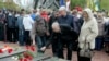 People lay flowers at a memorial bearing the names of victims of the Chernobyl nuclear accident, during a commemoration of the disaster's 30th anniversary, in Kyiv, Ukraine, April 26, 2016.