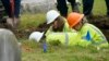 FILE - Oklahoma state archaeologist Kary Stackelbeck, center, watches as excavation begins at Oaklawn Cemetery in a search for victims of the Tulsa Race Massacre, on June 1, 2021, in Tulsa. She announced on Aug. 16, 2024, that three more bodies were found with gunshot wounds.