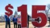 FILE - Activists appeal for a $15 minimum wage near the Capitol in Washington, Feb. 25, 2021.