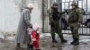 A woman accompanies her child to be evacuated from Avdiivka to Sviatohirsk, a town about 140 kilometers (88 miles) away and far from the conflict front line, in eastern Ukraine, Feb. 5, 2017. A sharp escalation in fighting between Ukrainian troops and Russia-backed rebels in the previous week had killed at least 33 people, centering on Avdiivka, a government-held town just north of rebel-controlled Donetsk.