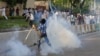  A Pakistani Muslim protester throws a tear gas shell back towards police as demonstrators attempt to reach the US embassy during a protest against an anti-Islam film in Islamabad, September 20, 2012.