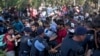 With people trampling and falling on each other amid the chaos, migrants push through a police line in Tovarnik, Croatia, Sept. 17, 2015.