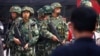 FILE - Paramilitary policemen stand guard in Urumqi, Xinjiang Uighur Autonomous region, in May 2014. The Islamic State may be reaching out to the Muslim Uighur populations, as al-Qaida did in the past.
