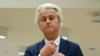 FILE - Populist anti-Islam lawmaker Geert Wilders prepares to address judges at the high-security court near Schiphol Airport, Amsterdam.