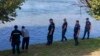 Serbian police officers search a bank of the Drina River near the town of Ljubovija, Serbia, on Aug. 22, 2024. (Serbian Ministry of Interior via AP)