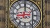 A British Union flag flutters in front of one of the clock faces of the 'Big Ben' clocktower of The Houses of Parliament in central London, Feb. 22, 2016