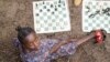 Arusi Wegeneza, 13, poses for a photo during a chess game at the Soga Chess Club of the internally displaced persons camp in Kanyaruchinya, Democratic Republic of Congo, on July 29, 2024.