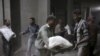 Men store bags of flour unloaded from a Red Crescent aid convoy in the rebel held besieged town of Jesreen, in the eastern Damascus suburb of Ghouta, Syria, March 7, 2016. 