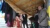 FILE - Jan Egeland, secretary-general of the Norwegian Refugee Council, listens to a Syrian family at a refugee camp in Marej, Lebanon.