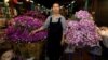 Ram, 46, poses for a photograph at her stall at the flower market in Bangkok, Thailand, Feb. 26, 2017.