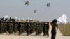 فائل - UH-60 بلیک ہاک ہیلی کاپٹر 14 اگست 2024 کو افغانستان کے صوبہ پروان کے بگرام ایئر بیس میں، افغانستان سے امریکی زیر قیادت فوجیوں کے انخلاء کی تیسری سالگرہ کے موقع پر ایک فوجی پریڈ کے دوران پرواز کر رہے ہیں۔