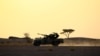 FILE - The Polisario Front soldiers drive a pick-up truck mounted with an anti-aircraft weapon during sunset in Bir Lahlou, Western Sahara, Sept. 9, 2016. 
