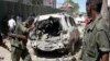 FILE - Security forces inspect the scene of a car bomb attack in the capital Mogadishu, Somalia, April 11, 2016. A car bomb exploded outside a restaurant packed with lunchtime customers, killing at least five people according to witnesses.