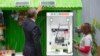 FILE - President Barack Obama looks at a solar power exhibit during a tour of the Power Africa Innovation Fair in Nairobi, Kenya, July 25, 2015. In Nigeria, Lumos Global is among the firms rolling out solar power technology. The company received financing from the U.S. government's Overseas Private Investment Corporation as part of Obama's Power Africa initiative.