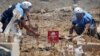 Civil defense members prepare to safely detonate cluster bombs in the rebel-held area in Deraa, Syria, July 26, 2017. 
