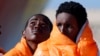 Migrants stand in line after disembarking from the Norwegian vessel Siem Pilot at Pozzallo's harbor, Italy, March 29, 2016. 