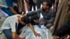Palestinians mourn a relative killed in the Israeli bombardment of the Gaza Strip, at a hospital in Khan Younis, Aug. 24, 2024.