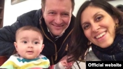 FILE - Richard Ratcliffe, center, is stepping up the fight to have his wife, Nazanin Ratcliffe, and daughter Gabriella released from Iran.