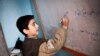 FILE - A Syrian boy attends class in a village near Aleppo, Syria, Dec. 17, 2012. 