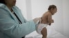 FILE - Lara, who was born with microcephaly, is examined by a neurologist at the Pedro I hospital in Campina Grande, Paraiba state, Brazil, Feb. 12, 2016.