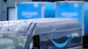 FILE - An Amazon Prime logo appears on the side of a delivery van as it departs an Amazon warehouse location in Dedham, Massachusetts, Oct. 1, 2020.
