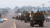 FILE - Congo military trucks carrying Congolese troops drive in a main street after violence erupted due to the delay of the presidential elections in Kinshasa, Democratic Republic of the Congo, Sept. 20, 2016.