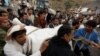 People carry the body of a woman they recovered from under the rubble of a house destroyed by a Saudi-led airstrike in Sanaa, Yemen, Aug. 25, 2017. 