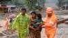 Rescuers help residents to move to a safer place, at a landslide site after multiple landslides in the hills, in Wayanad, in the southern state of Kerala, India, July 30, 2024. 