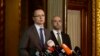 Hungarian Foreign Minister Peter Szijjarto, with government spokesman Zoltan Kovacs at right, during a news conference about his country's plans to build a fence along the Hungarian-Serbian border to try to stop refugees, June 17, 2015.