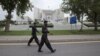 Paramilitary soldiers walk past the Supreme Court building in Islamabad, August 8, 2012. 